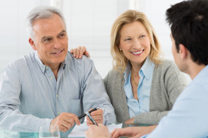 Portrait Of Happy Senior Couple Talking With A Young Man